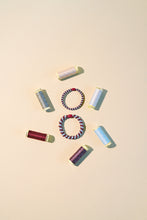 Laden Sie das Bild in den Galerie-Viewer, Haargummi Slim Rosewood seablue glitter